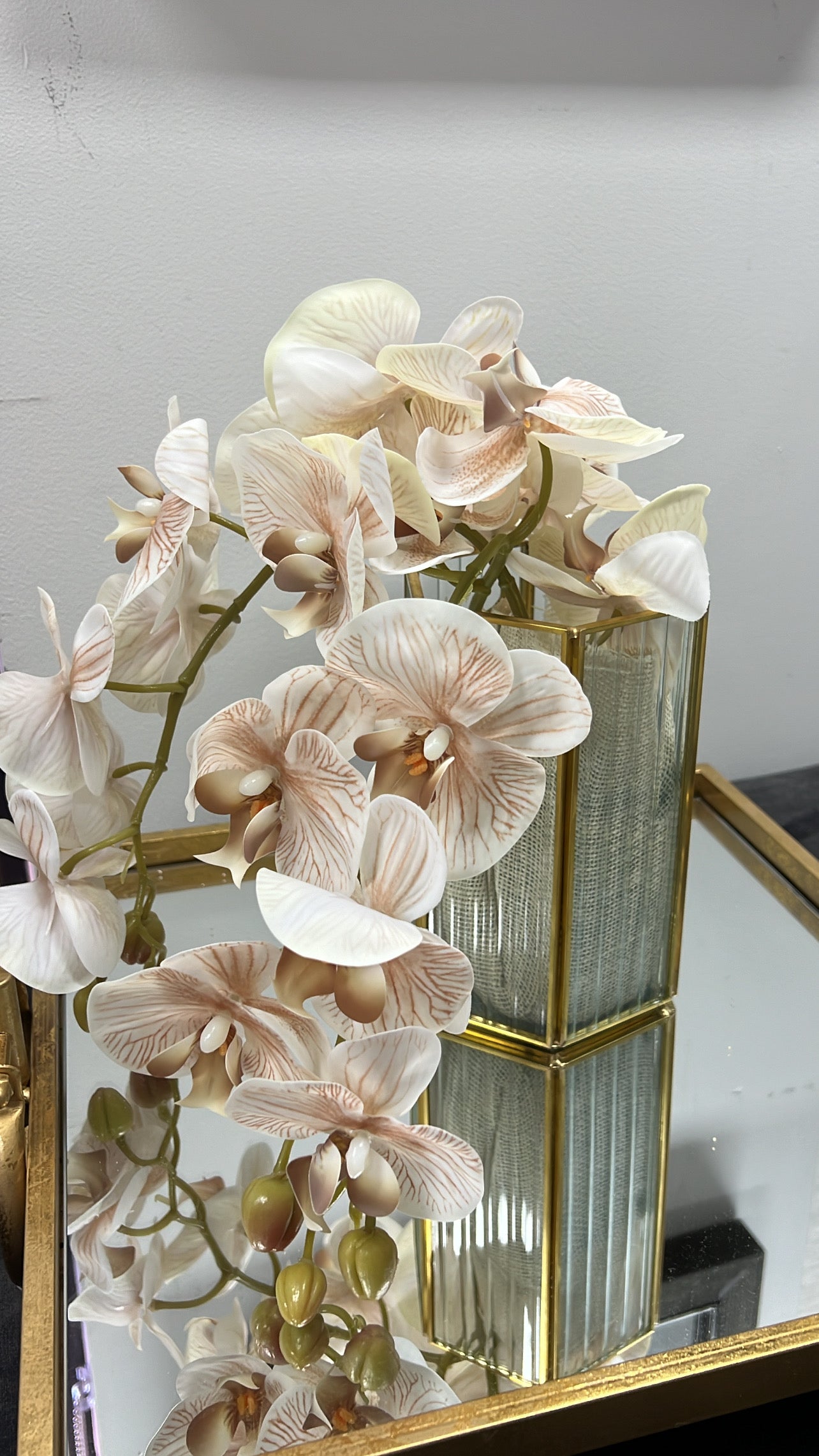 Gold ribbed glass vase and neutral orchids